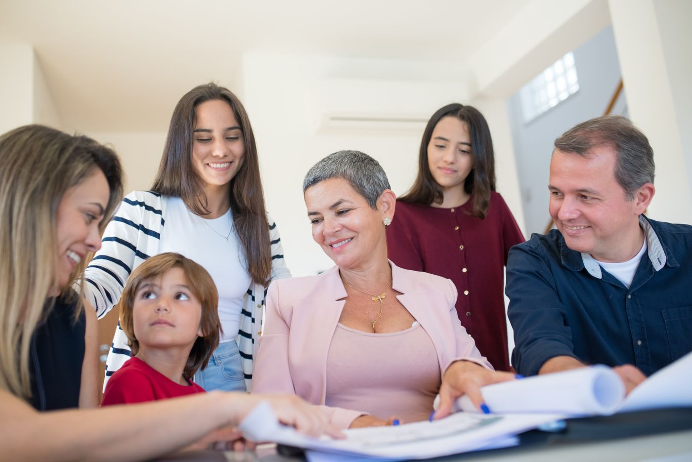 Family reviewing documents at a table